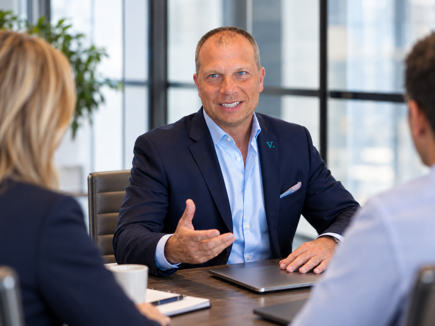 V.law team member meeting with clients at a conference table